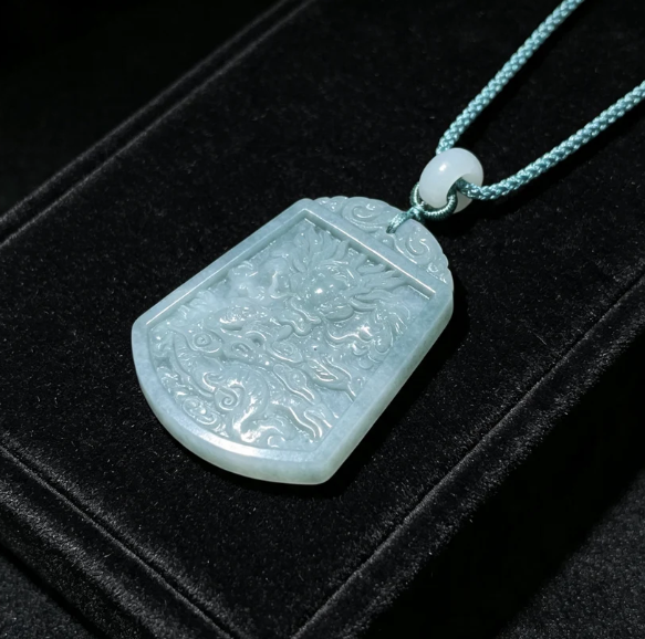 Hand-carved jade pendant featuring a landscape relief
