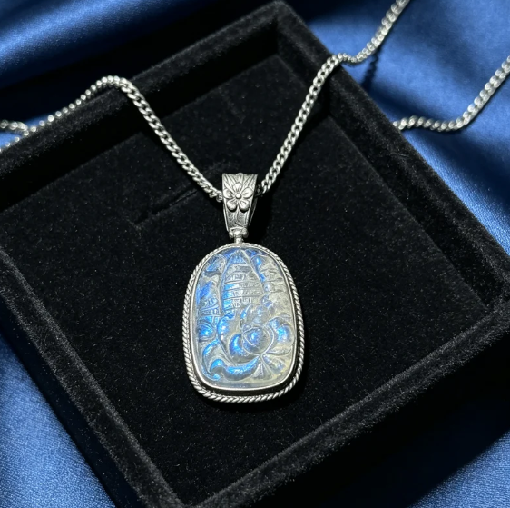 Hand-carved natural labradorite pendant with a vintage-style ethnic metal setting.
